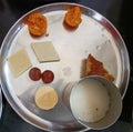 Indian sweets such as Ladoo, peda, gulab jamun, cashew barfi, Chennai poda etc. Served with butter milk
