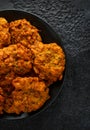 Indian takeaway food, spicy onion bhajis on black plate Royalty Free Stock Photo