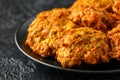 Indian takeaway food, spicy onion bhajis on black plate Royalty Free Stock Photo