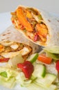 Indian tandoori chicken roll or twister with side salad on white plate