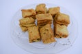 Indian tea time snack Khaari biscuit. Namkeen salty Masala khari served in white plate. Close up white background. Indian munching