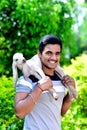 Indian Teen Age Boy Holding Baby Goat On His Shoulder Smiley Face Royalty Free Stock Photo