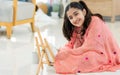 Indian teen girl wearing traditional clothes, playing alone, using brush painting art on plate in leisure time with happiness, Royalty Free Stock Photo