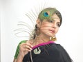 Indian teenage girl holding peacock feather