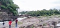 A Indian three friends take pictures in a waterfall. In Damodar River valley In Bhatinda waterfall Dhanbad Jharkhand