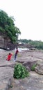 A Indian three friends take pictures in a waterfall. In Damodar River valley In Bhatinda waterfall Dhanbad Jharkhand