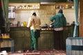 Indian or tibetan family cooking food for dinner in kitchen room of guest house of Leh Ladakh village at Himalayan valley