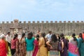 Indian tourists in grounds outside near Tower of Pisa in group taking photos