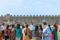 Indian tourists in grounds outside near Tower of Pisa in group taking photos