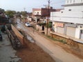 Indian town narrow road after rain having small patches filled with water