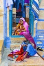 Indian traditional family. women reparing clothes