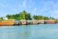 Indian traditional house boats anchored at Pamba river coastline, with palms at the background, Alappuzha, Kerala, South India