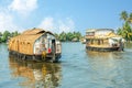 Indian traditional houseboats floating on Pamba river, with palms at the coastline, Alappuzha, Kerala, South India Royalty Free Stock Photo