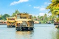 Indian traditional houseboats floating on Pamba river, with palms at the coastline, Alappuzha, Kerala, South India Royalty Free Stock Photo