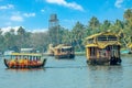 Indian traditional houseboats floating on Pamba river, with palms at the coastline, Alappuzha, Kerala, South India Royalty Free Stock Photo