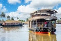 Indian traditional houseboats floating on Pamba river, with palms at the coastline, Alappuzha, Kerala, South India