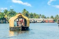 Indian traditional living houseboats floating on Pamba river, with palms at the coastline, Alappuzha, Kerala, South India Royalty Free Stock Photo