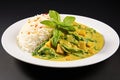 Indian traditional meal with rice, curry, chicken and herbs served on plate