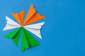 Indian tricolor paper planes arranged in circular shape on blue background. Conceptual image for Indian national day celebration a