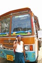 Indian truck driver talking on his mobile phone on the roadside of the highways.