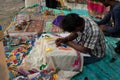 An Indian unidentified artist paints on colourful handicraft items for sale in Kolkata in handicrafts trade fair. It is rural