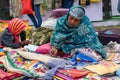 An Indian Unidentified middle-aged woman paints on colourful handicraft items for sale in Kolkata in handicrafts trade fair. It is