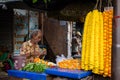 An Indian unidentified seller selling colourful flowers at his cart in the local market in Kolkata, India on October 2020