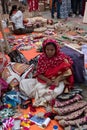 An Indian Unidentified woman preparing jute made coasters for sale in Kolkata in handicrafts trade fair. It is rural Industry in Royalty Free Stock Photo