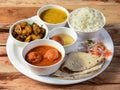 Indian Veg Kofta curry Thali / food platter consists variety of veggies, lentils, sweet dish, snacks etc., selective focus Royalty Free Stock Photo