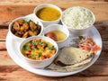 Indian Veg Rajasthani Thali / food platter consists variety of veggies, lentils, sweet dish, snacks etc., selective focus