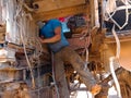 an indian vehicle mechanic working under the truck at workshop in india dec 2019