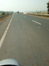 INDIAN VILLAGE ROAD ,SIDE TREE AND PLANT IMAGE WITH ROAD BARICATE, BOTH SIDE TREES AND BEAUTIFUL SUNSHINE