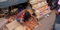 an indian village boy selling soil made lamp on street during diwali festival