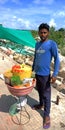 an indian village boy selling street food at tourist place