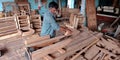 An indian village carpenter working on wooden work factory