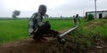 An indian village farmer installing water pipe for irrigation purpose at agriculture produce land