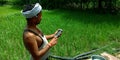 An indian village farmer operating smart phone at agriculture green field