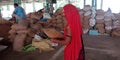 Indian village farmer woman filtering dust from wheat grain at farmers produce market