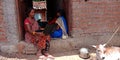 An indian village farmer women using laptop computer system seating at corridor