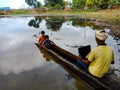 an indian village fisherman holded laptop during sailing boat on the river in India January 2020