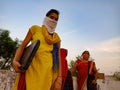 An indian village girl holded laptop computer wearing face mask in india May 2020