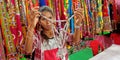 an indian village girl selling women artificial jwellary item into the store Royalty Free Stock Photo