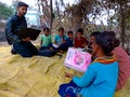 indian village government school students studying at open area class village about laptop system in India January 1, 2020