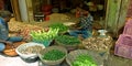 an indian village green seller giving fresh veggies to the customer