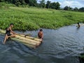 Indian village kids enjoying with their handmade Banana boat on the summer time at Tinsukia, Assam, India on 21st June 2019