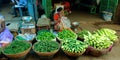 an indian village lady greengrocer selling agricultural products at farmers market