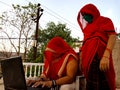 An indian village lady teaching matured woman about computer technology wearing face mask in india May 2020