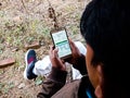 An indian village man using smart phone at agriculture land in india dec 2019 Royalty Free Stock Photo