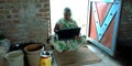 An indian village matured farmer woman working on laptop while seating at corridor Royalty Free Stock Photo