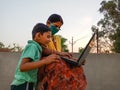 An indian village mother teaching her son about computer technology wearing face mask in india May 2020